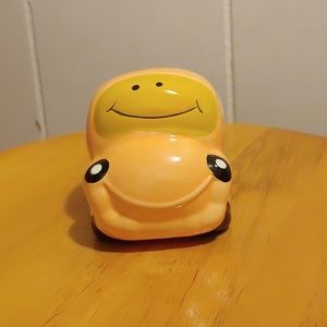 Smily face ceramic car bank.